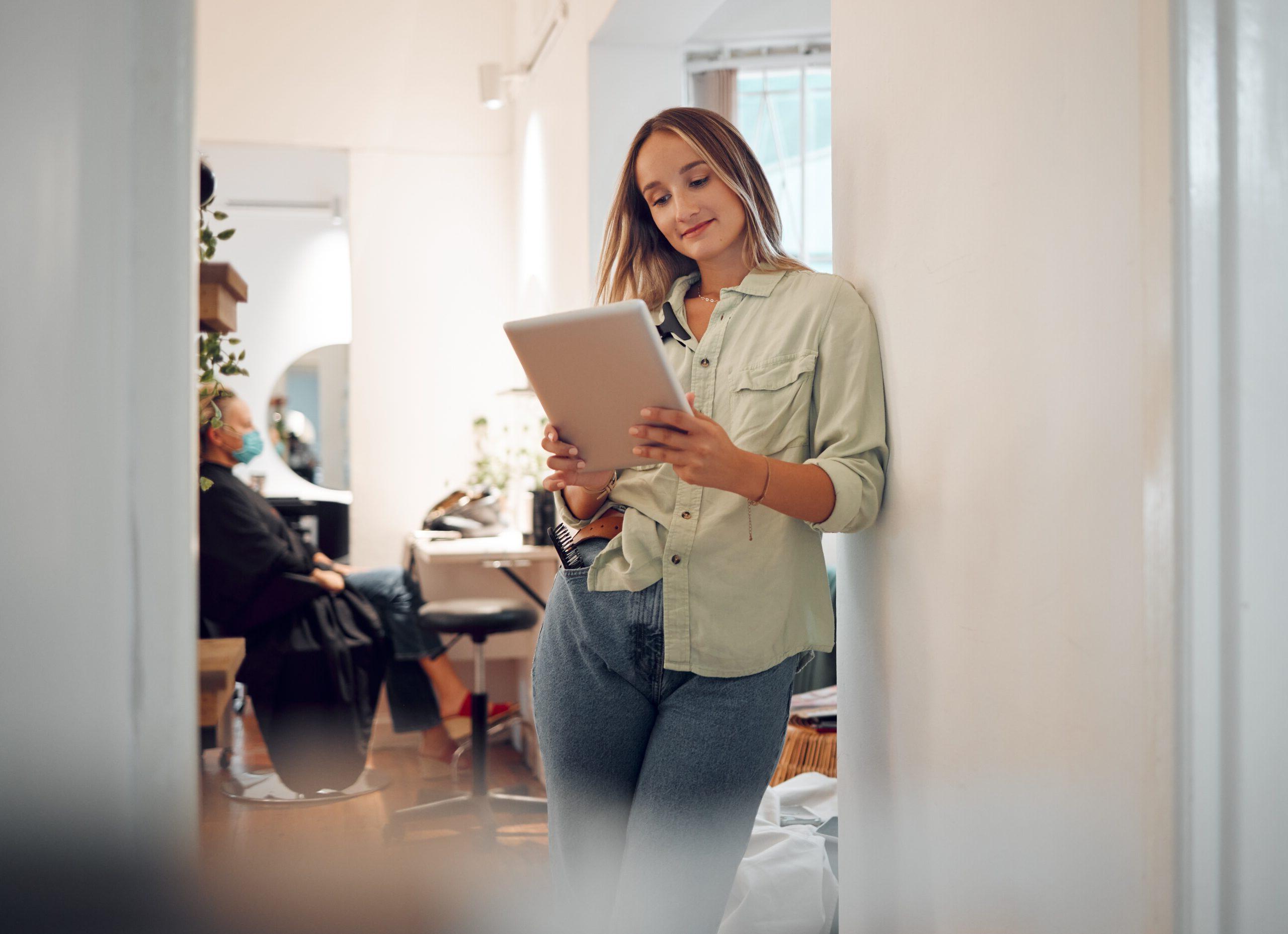 Woman salon owner reviewing business resources